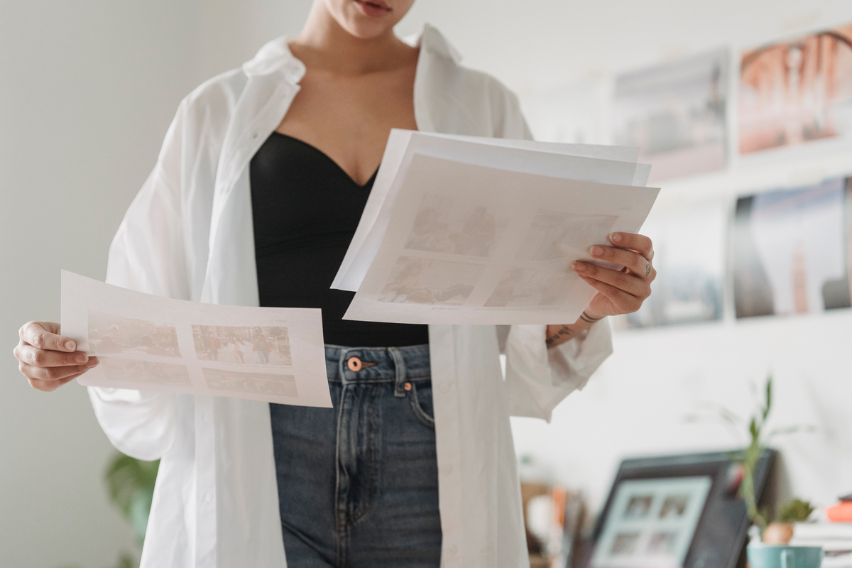 Crop designer with paper sheets working at home